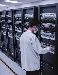 Technician testing a Supermicro SuperRack build in a factory environment